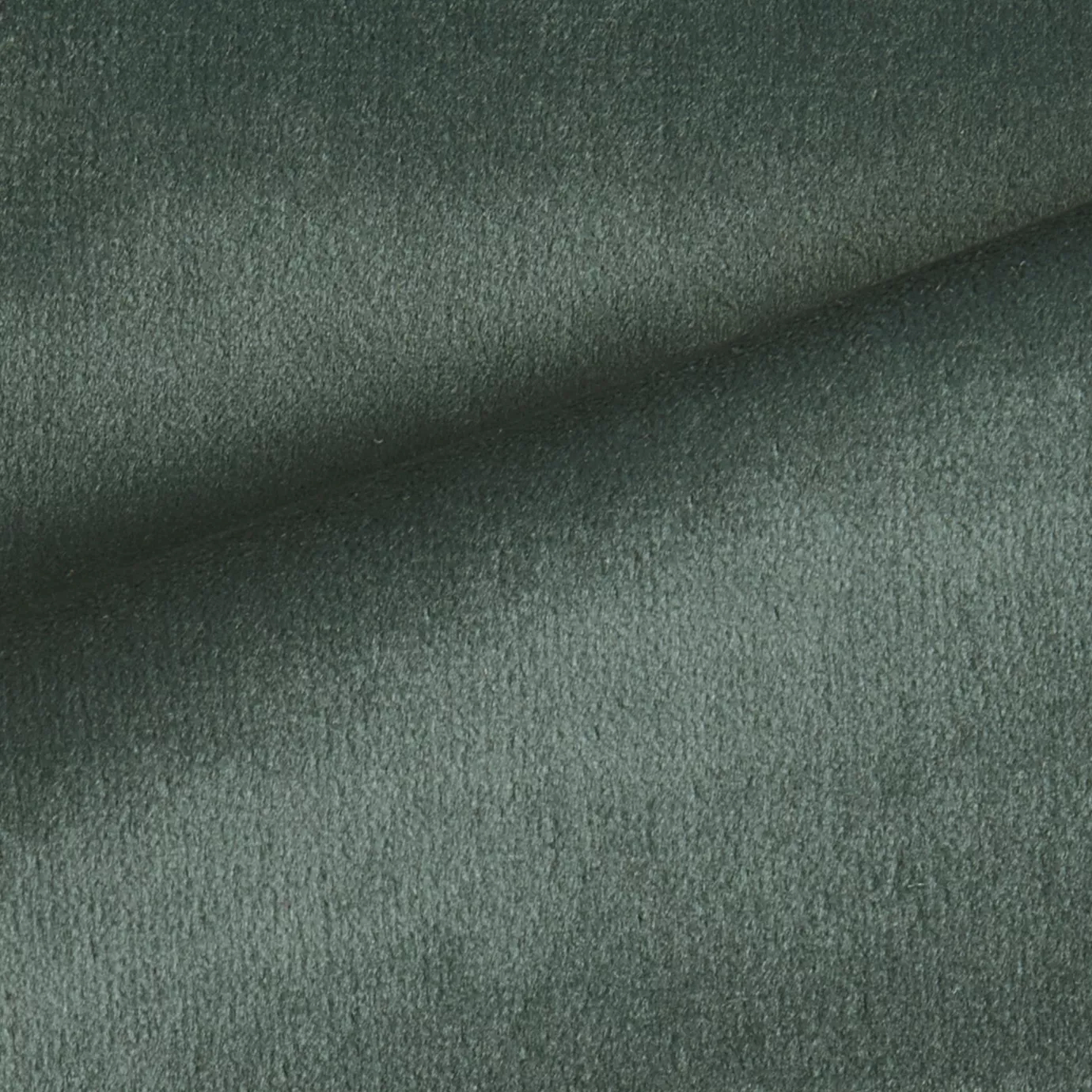 Elegant close-up of a Radiance Velvet Deep Baltic fabric swatch in a deep and sophisticated gray-green tone, showcasing its velvety texture and the gentle folds that highlight its natural and welcoming elegance.
