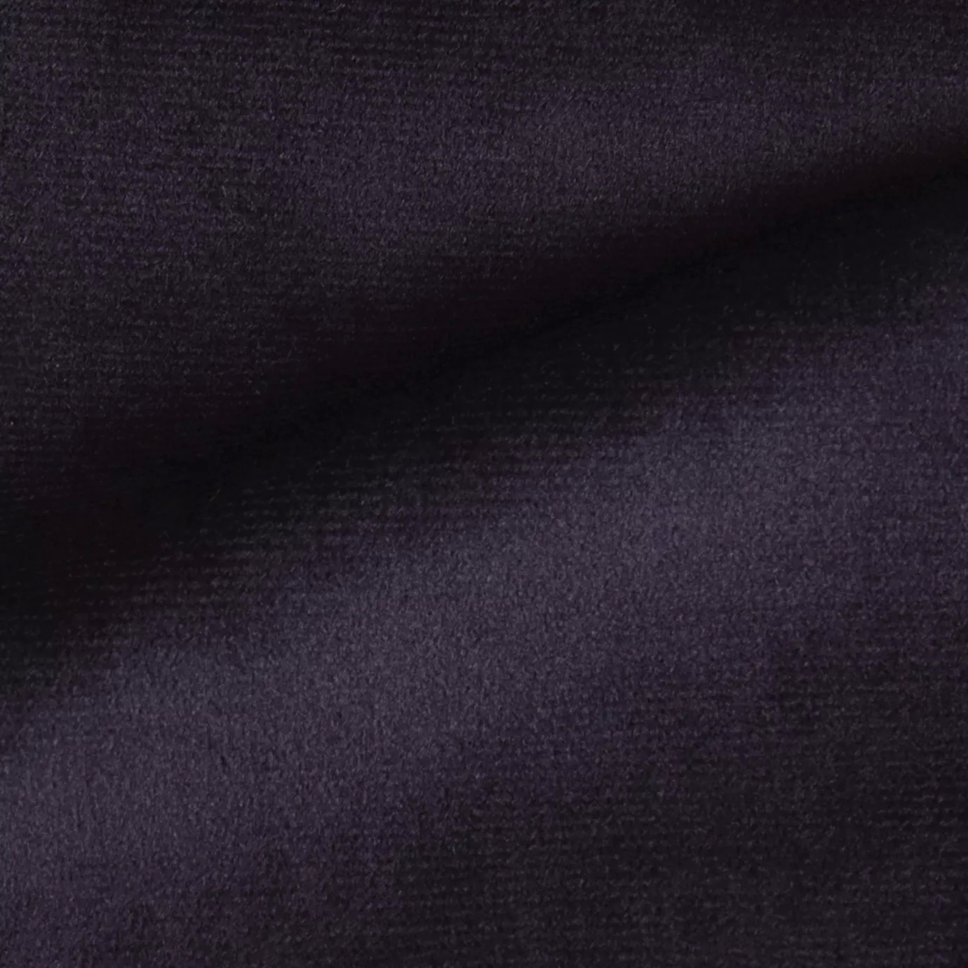 Elegant close-up of a Radiance Velvet Deep Purple fabric swatch in a deep and sophisticated purple tone, showcasing its velvety texture and the gentle folds that highlight its rich and welcoming elegance.