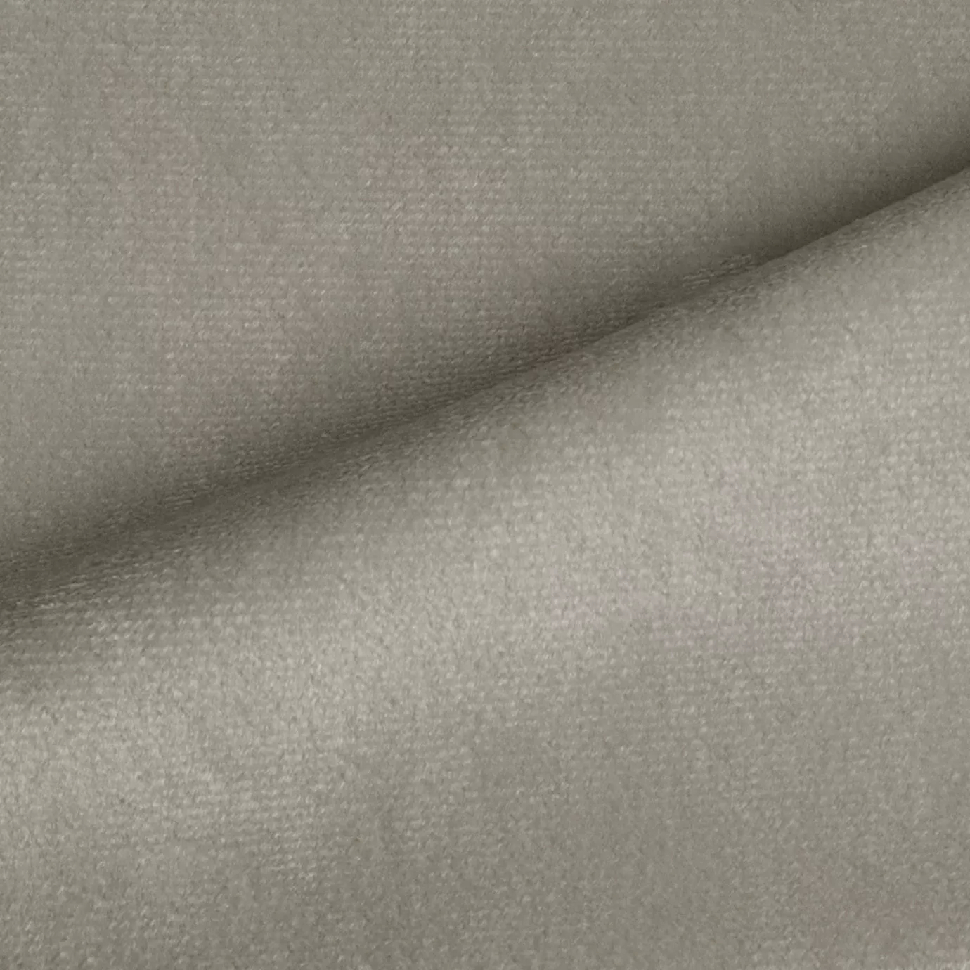 Elegant close-up of a Radiance Velvet Light Greige fabric swatch in a light and luminous gray-beige tone, showcasing its velvety texture and a subtle sheen that gives it a feeling of natural and soft sophistication.