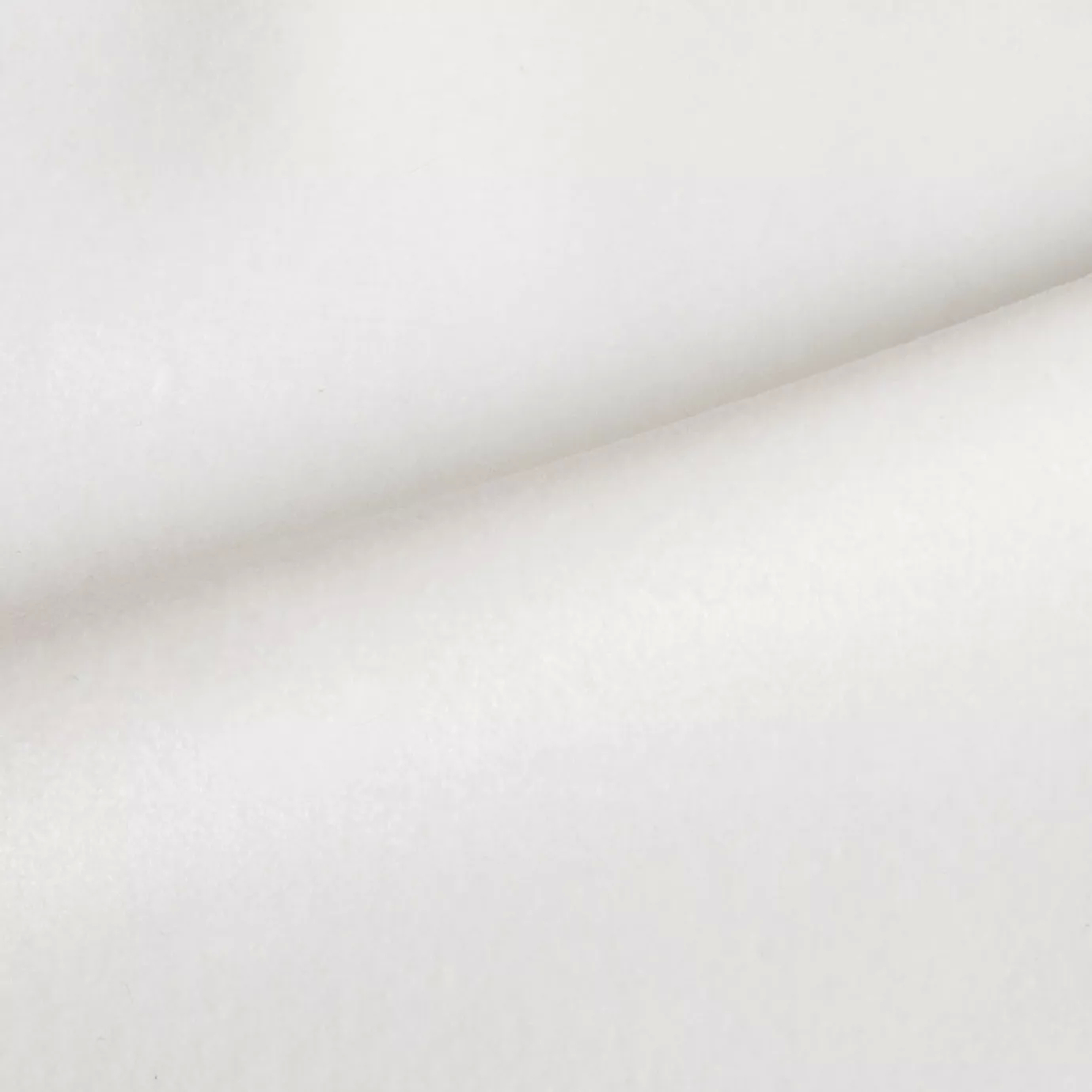 Elegant close-up of a Radiance Velvet White fabric swatch in a pure and luminous white tone, showcasing its velvety texture and a subtle sheen that gives it a feeling of lightness and timeless elegance.