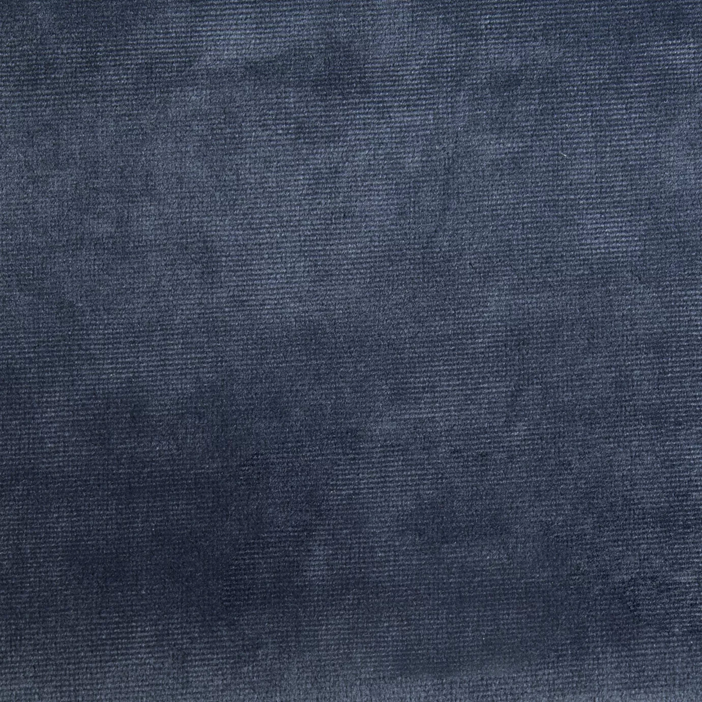 Elegant close-up of a Paris Velvet Ocean fabric swatch in a deep and soft ocean blue tone, showcasing its velvety texture and a subtle sheen that gives it a feeling of comfort and serene elegance.