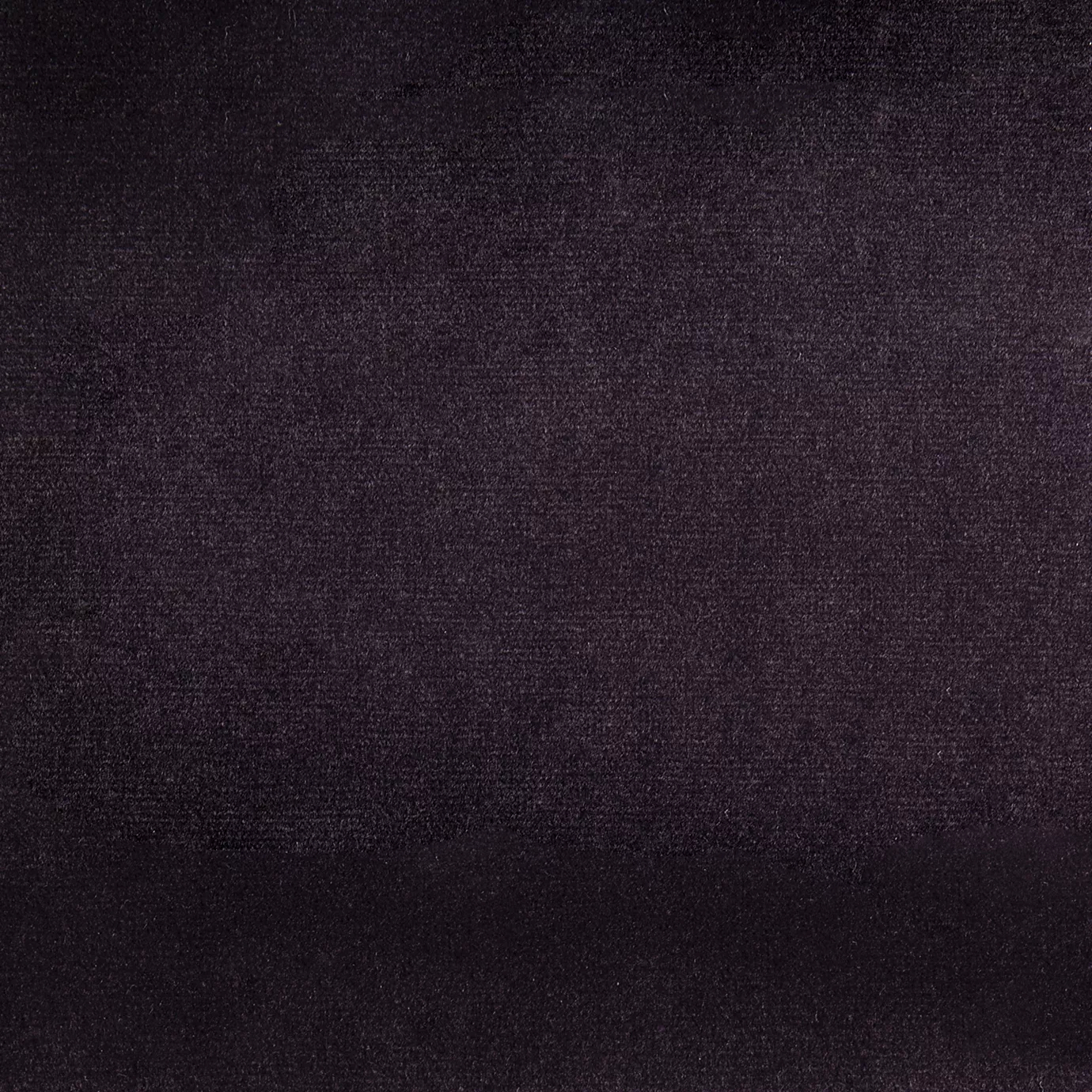 Elegant close-up of a Paris Velvet Purple fabric swatch in a deep and sophisticated purple tone, showcasing its velvety texture and a subtle sheen that gives it a feeling of comfort and rich elegance.