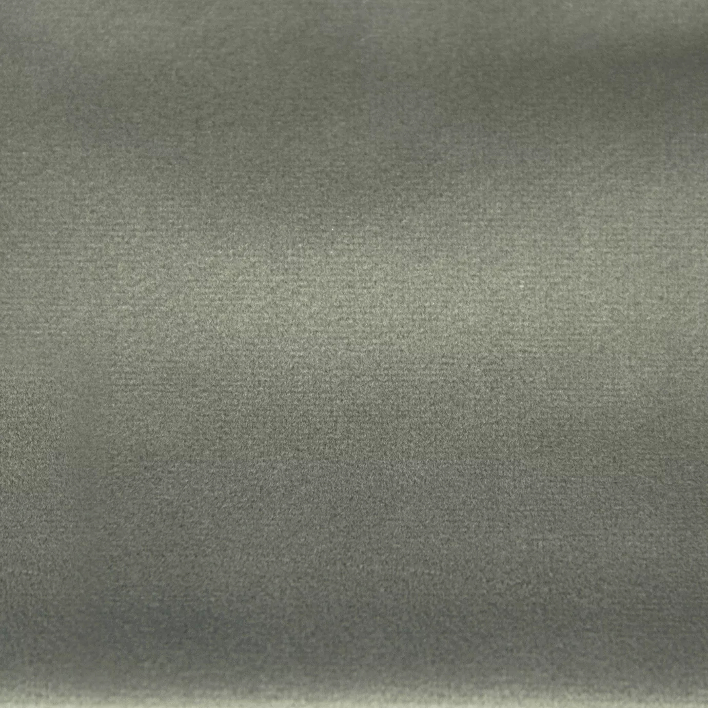 Soft and elegant close-up of a Lux Velvet Aquarelle 0865 fabric swatch in a light and serene gray tone, showcasing its velvety texture and a delicate sheen that gives it a feeling of comfort and understated elegance.