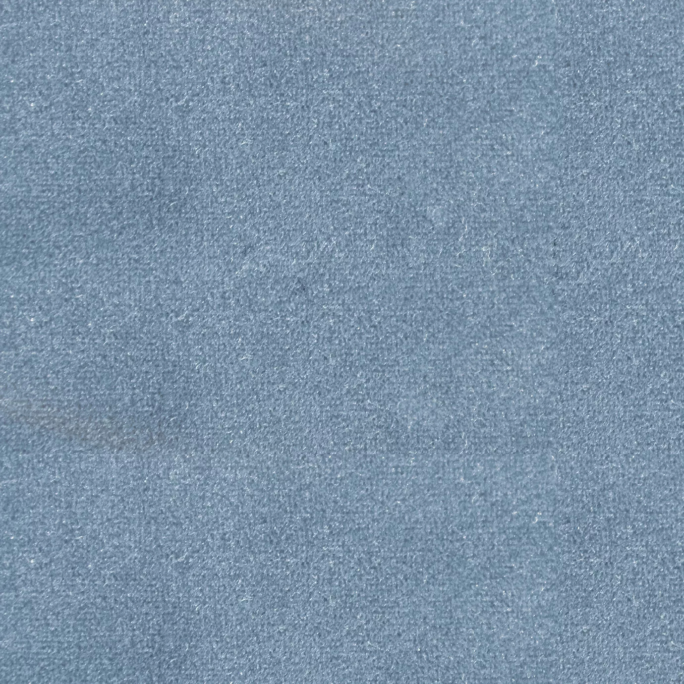 Soft and elegant close-up of a Lux Velvet Baby Blue 6031 fabric swatch in a soft and delicate baby blue tone, showcasing its velvety texture and a delicate sheen that gives it a feeling of comfort and serene elegance.