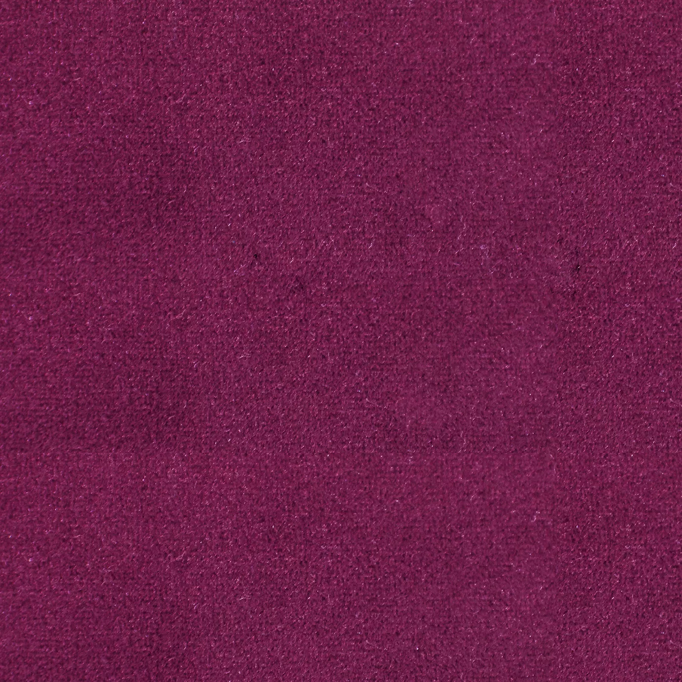 Soft and elegant close-up of a Lux Velvet Magenta 0539 fabric swatch in a vibrant and sophisticated magenta tone, showcasing its velvety texture and a delicate sheen that gives it a feeling of comfort and intense elegance.