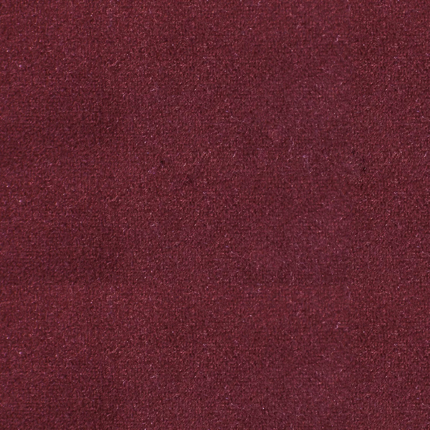 Soft and elegant close-up of a Lux Velvet Rubi 0343 fabric swatch in a rich and sophisticated ruby red tone, showcasing its velvety texture and a delicate sheen that gives it a feeling of comfort and rich elegance.