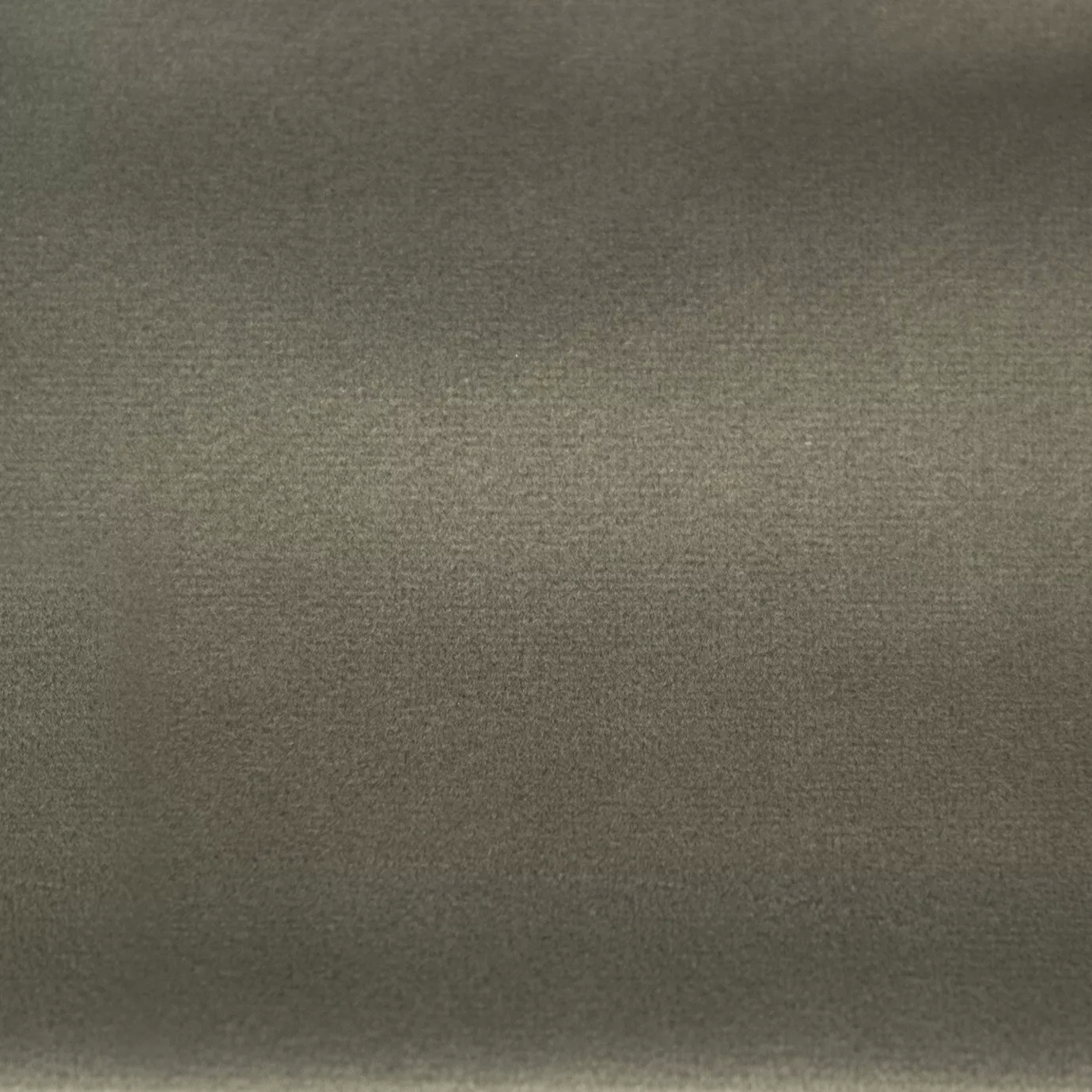 Soft and elegant close-up of a Lux Velvet Stone 0893 fabric swatch in a natural and sophisticated stone gray tone, showcasing its velvety texture and a delicate sheen that gives it a feeling of comfort and understated elegance.