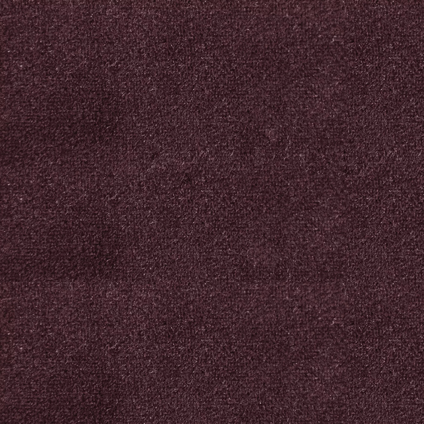 Soft and elegant close-up of a Lux Velvet Syrah 0371 fabric swatch in a rich and sophisticated syrah wine tone, showcasing its velvety texture and a delicate sheen that gives it a feeling of comfort and intense elegance.