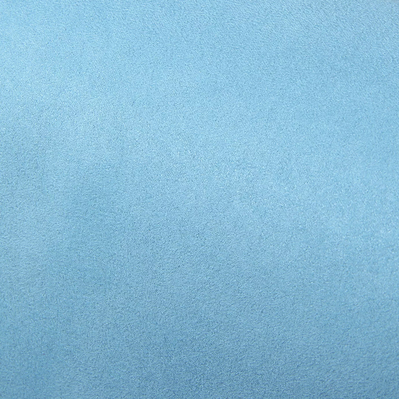 Soft close-up of an Ultra Suede Angel Blue fabric swatch in a soft and serene sky blue tone, showcasing its delicate texture and a gentle touch that gives it a feeling of comfort and understated elegance.