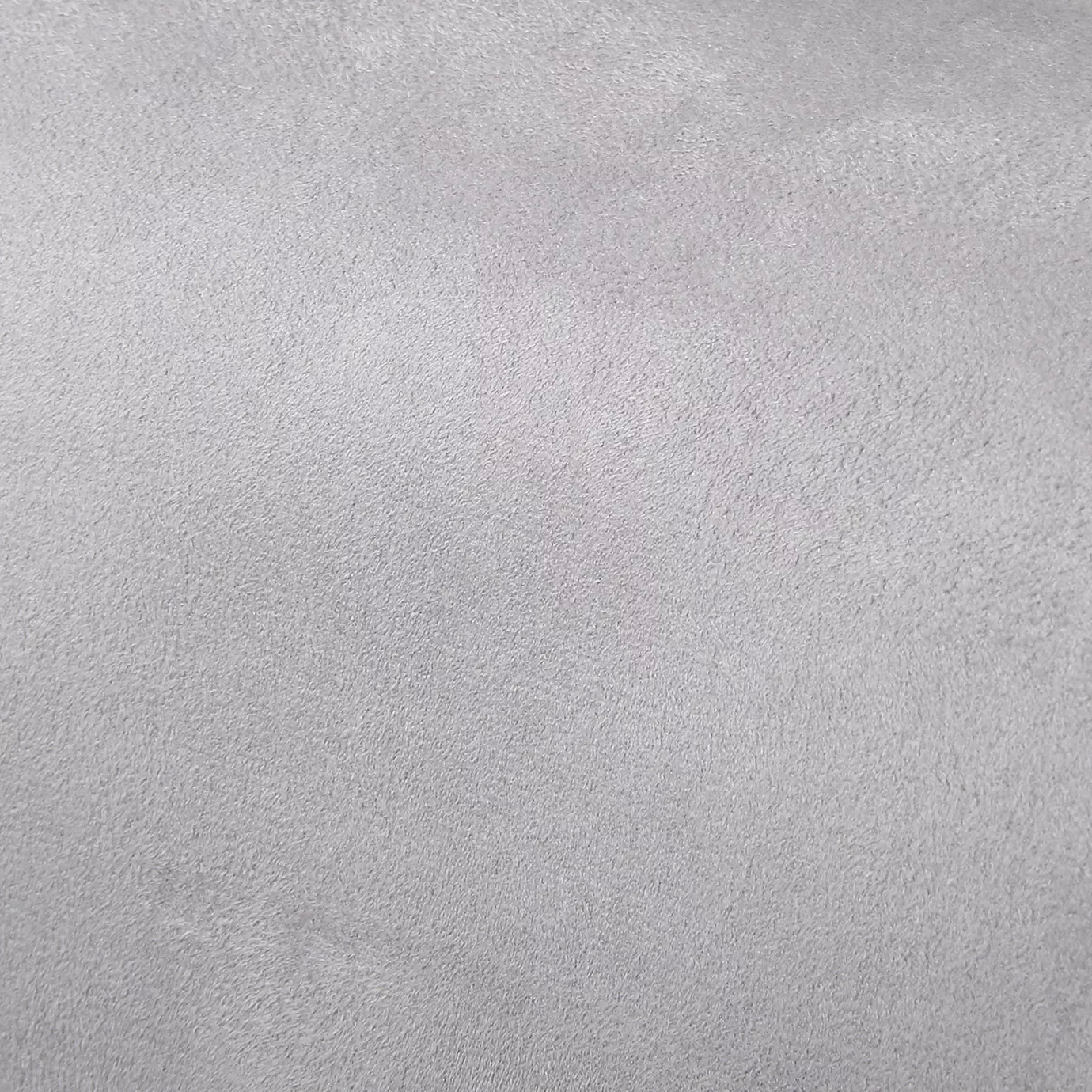 Soft close-up of an Ultra Suede Ashes of Rose fabric swatch in a pale and sophisticated grayish-pink tone, showcasing its delicate texture and a gentle touch that gives it a feeling of comfort and understated elegance.