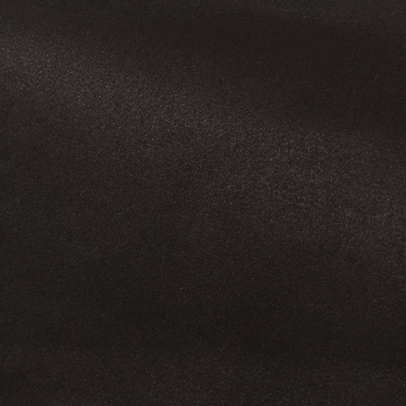 Soft close-up of an Ultra Suede Black Ink fabric swatch in a deep and sophisticated black ink tone, showcasing its delicate texture and a gentle touch that gives it a feeling of comfort and timeless elegance.