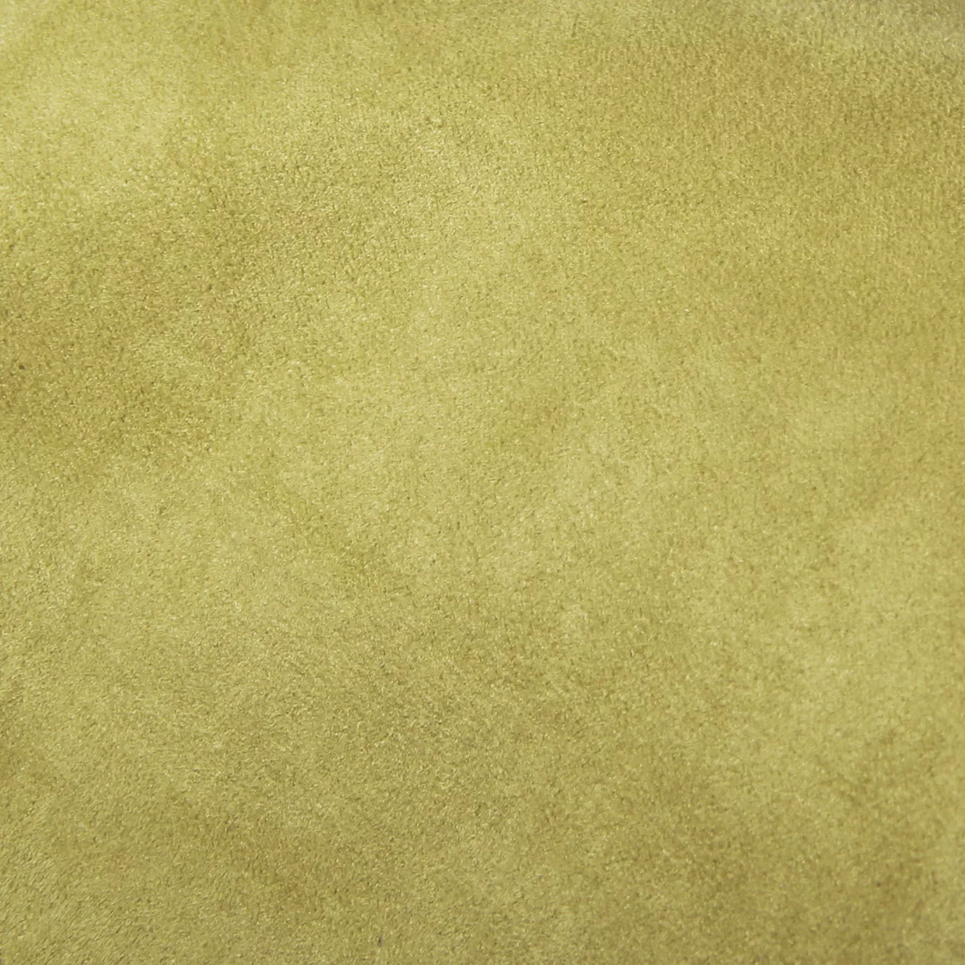 Soft close-up of an Ultra Suede Celery Green fabric swatch in a soft and natural celery green tone, showcasing its delicate texture and a gentle touch that gives it a feeling of comfort and understated elegance.