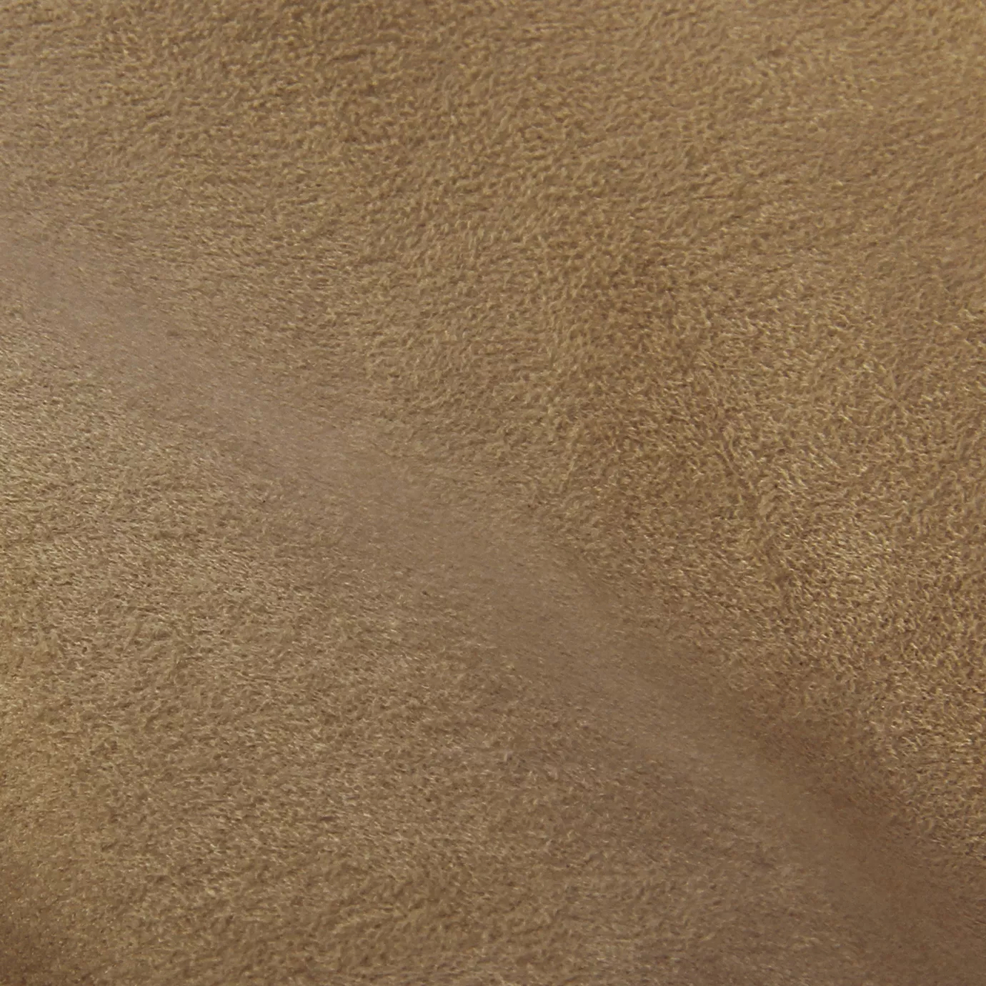 Soft close-up of an Ultra Suede Flax fabric swatch in a light and natural brown tone, showcasing its delicate texture and a gentle touch that gives it a feeling of comfort and understated elegance.