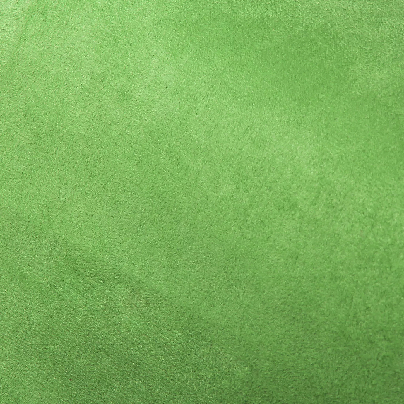 Soft close-up of an Ultra Suede Island Green fabric swatch in a vibrant and cheerful island green tone, showcasing its delicate texture and a gentle touch that gives it a feeling of comfort and natural elegance.