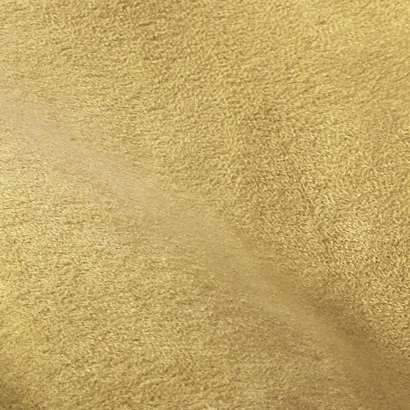 Soft close-up of an Ultra Suede Pale Banana fabric swatch in a pale and soft yellow tone, showcasing its delicate texture and a gentle touch that gives it a feeling of comfort and understated elegance.