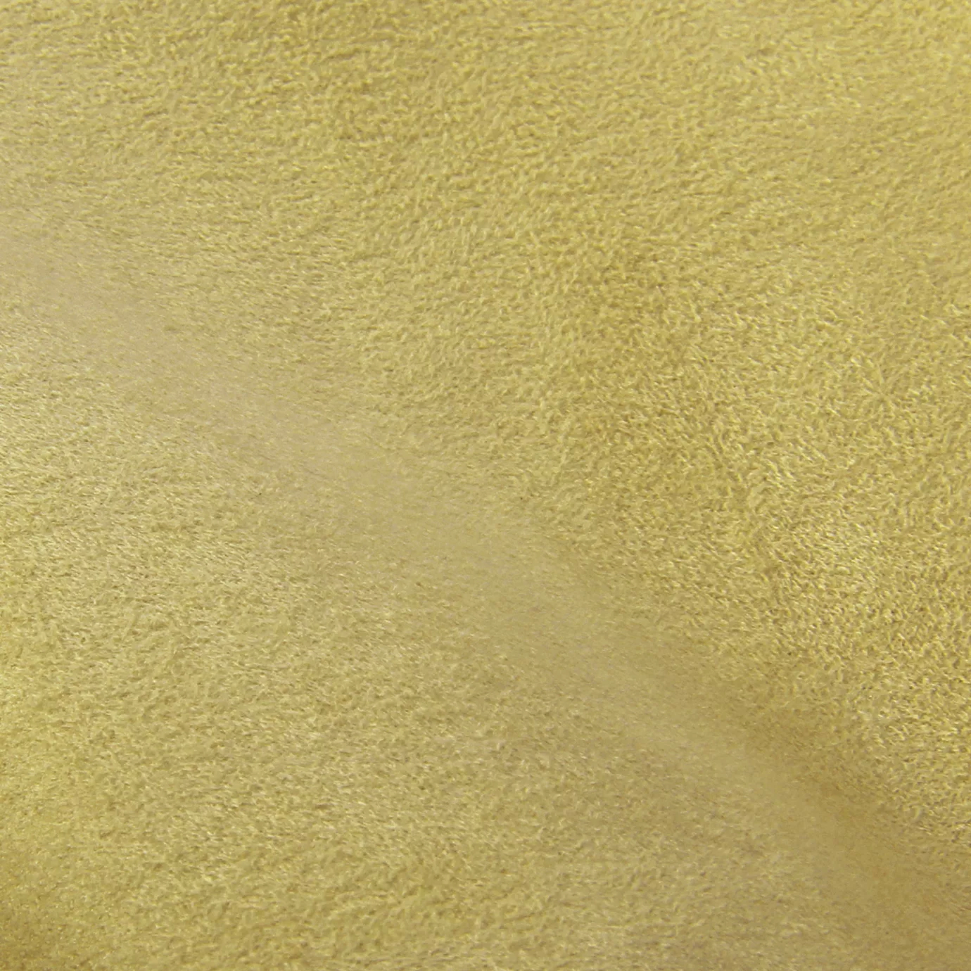Soft close-up of an Ultra Suede Pebble fabric swatch in a light and natural yellow tone, showcasing its delicate texture and a gentle touch that gives it a feeling of comfort and understated elegance.