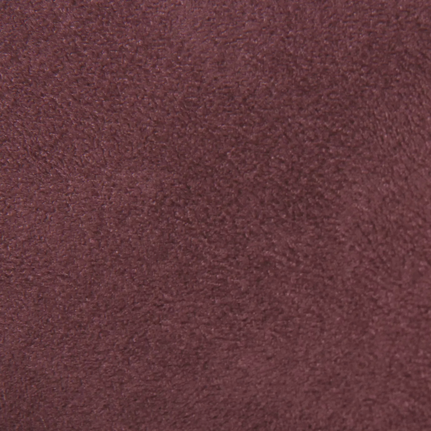Soft close-up of an Ultra Suede Wild Ginger fabric swatch in a warm and natural brownish-pink tone, showcasing its delicate texture and a gentle touch that gives it a feeling of comfort and understated elegance.