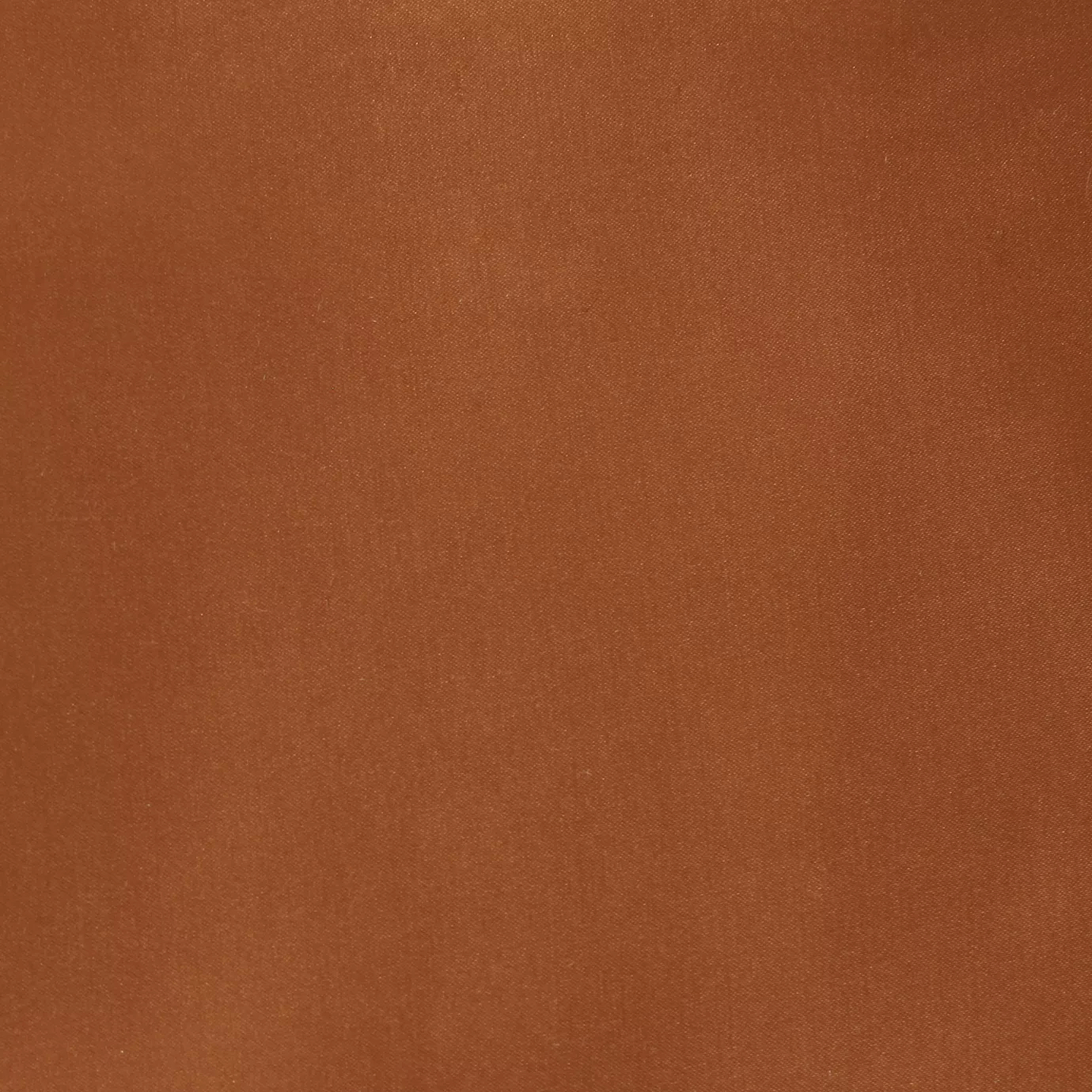 Soft close-up of a Satina Lux Orange fabric swatch in a warm and elegant orange tone, showcasing its smooth texture and a subtle sheen that gives it a feeling of sophistication and energy.