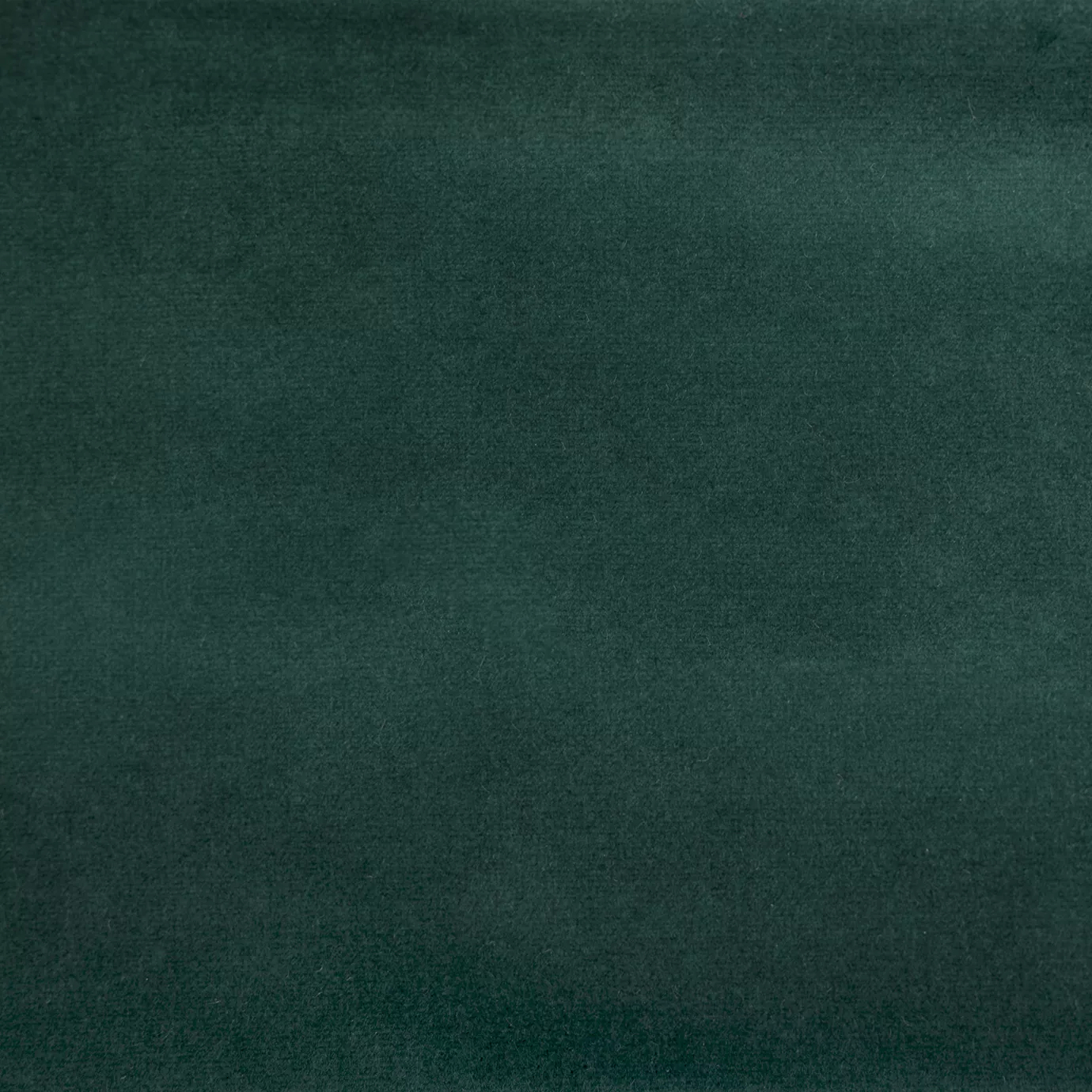 Soft close-up of a Smooth Velvet Dark Green fabric swatch in a deep and elegant dark green tone, showcasing its velvety texture and a gentle sheen that gives it a feeling of sophistication and cozy comfort.