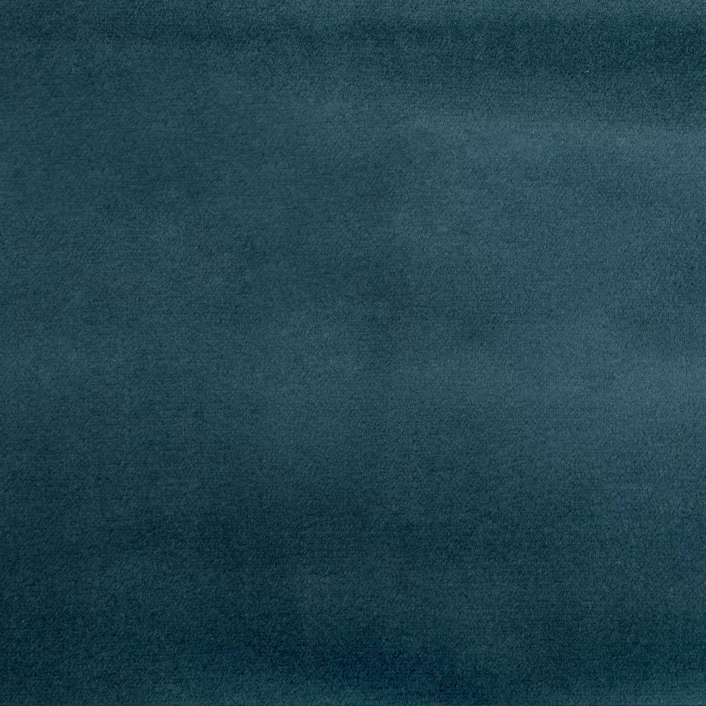 Soft close-up of a Smooth Velvet Storm Blue fabric swatch in a deep and elegant storm blue tone, showcasing its velvety texture and a gentle sheen that gives it a feeling of sophistication and cozy comfort.