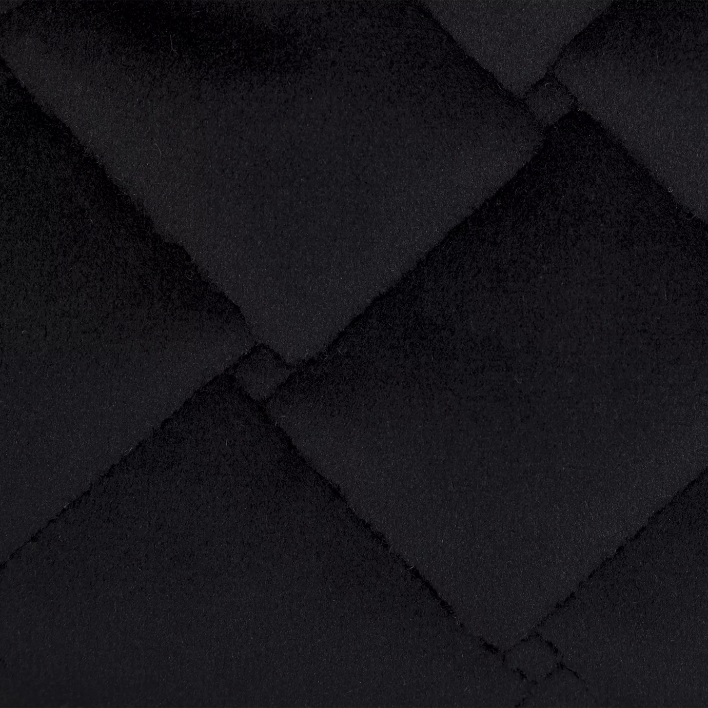 Elegant close-up of a Cloud Velvet Black fabric swatch in a deep and rich black tone, featuring a diamond-quilted pattern that gives it a voluminous texture and a luxurious touch, conveying a feeling of sophistication and timeless elegance.