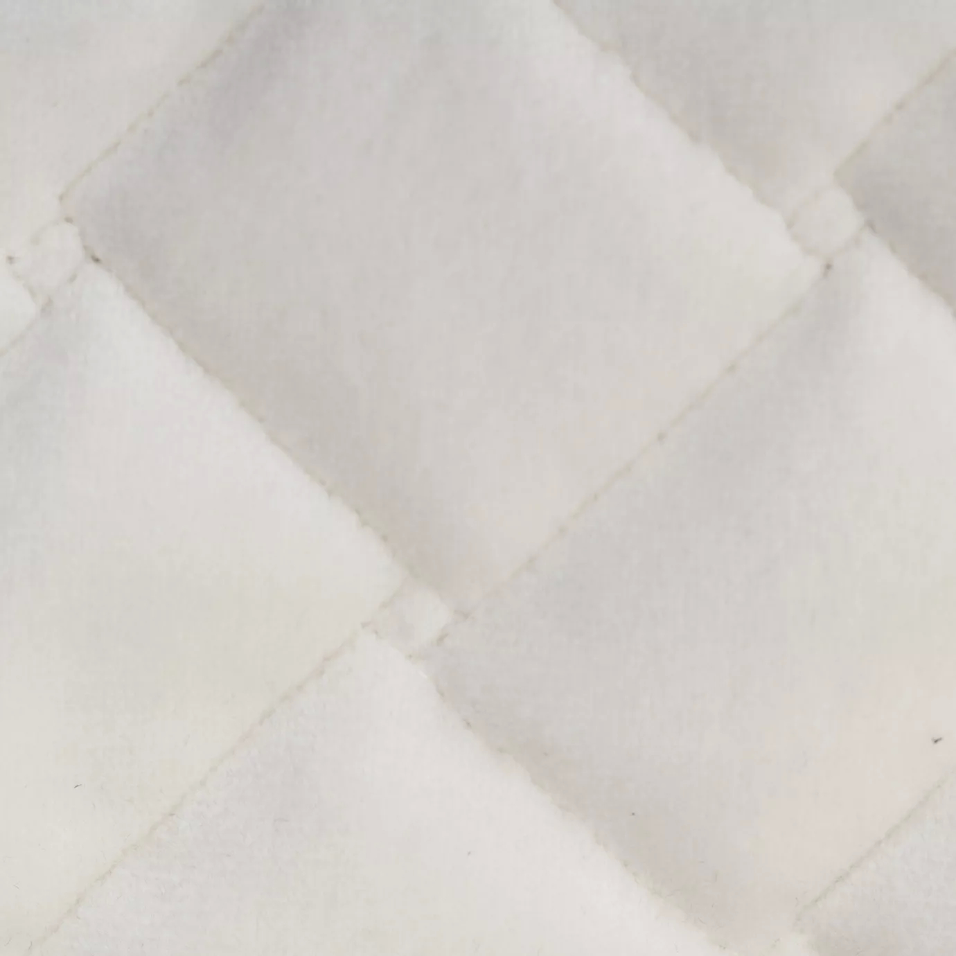 Elegant close-up of the Cloud Velvet Ivory fabric with a soft texture and diamond-quilted pattern in ivory color.