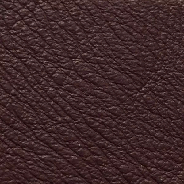 Close-up of a Harbor Andorra fabric swatch in a deep burgundy red tone with texture, showcasing its raised areas and grooves that give it a natural and elegant feel. The soft sheen highlights the depth of its texture.