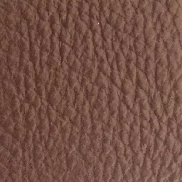 Close-up of a Harbor Cinnamon fabric swatch in a warm cinnamon brown tone with texture, showcasing its raised areas and grooves that give it a natural and elegant feel. The soft sheen highlights the depth of its texture.
