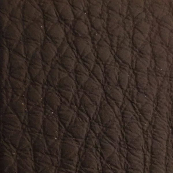 Close-up of a Harbor Java fabric swatch in a rich coffee brown tone with texture, showcasing its raised areas and grooves that give it a natural and elegant feel. The soft sheen highlights the depth of its texture.