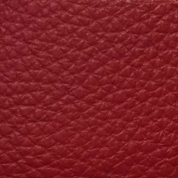 Close-up of a Harbor Mars Red fabric swatch in an intense Martian red tone with texture, showcasing its raised areas and grooves that give it a natural and elegant feel. The soft sheen highlights the depth of its texture.