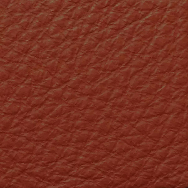 Close-up of a Harbor Rust fabric swatch in a warm rust tone with texture, showcasing its raised areas and grooves that give it a natural and elegant feel. The soft sheen highlights the depth of its texture.