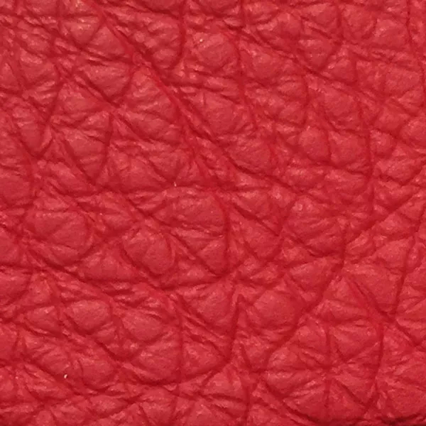 Close-up of a Harbor True Red fabric swatch in a vibrant red tone with texture, showcasing its raised areas and grooves that give it a natural and elegant feel. The soft sheen highlights the depth of its texture.