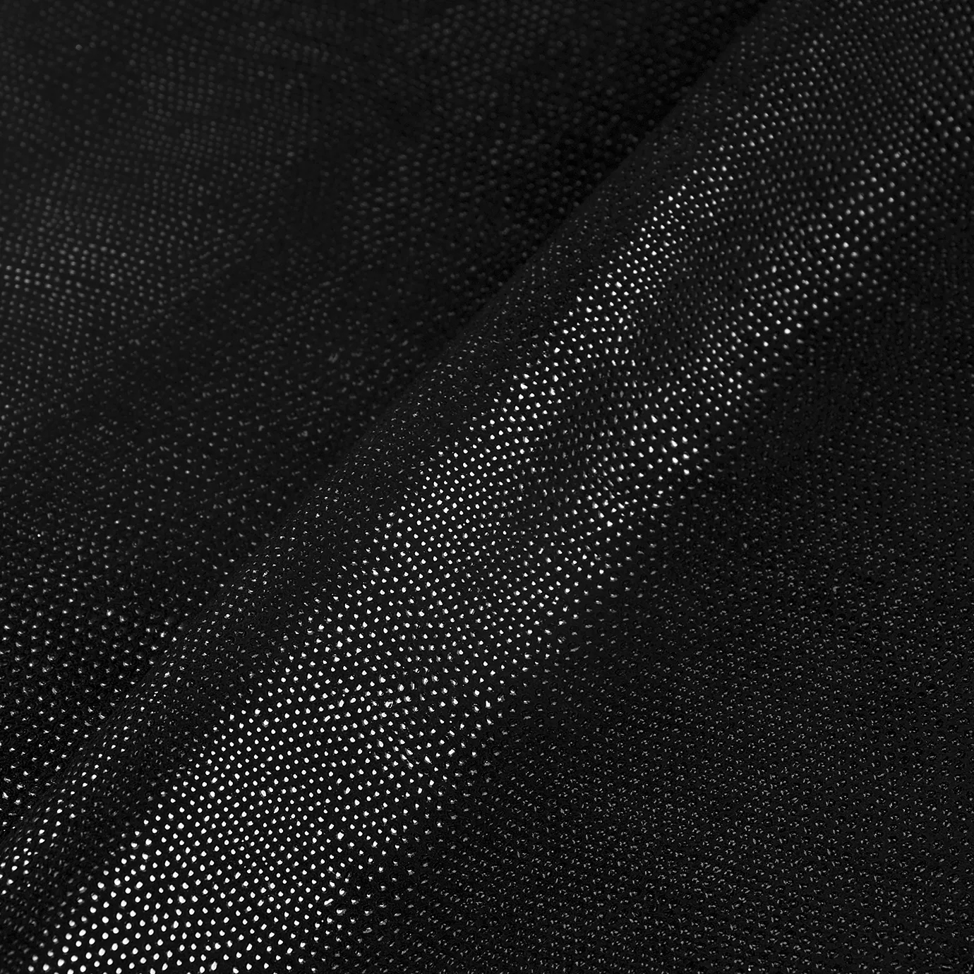 Close-up Pixel Silver Leather: textured black fabric with small, shiny silver dots. Features soft folds and light reflections.