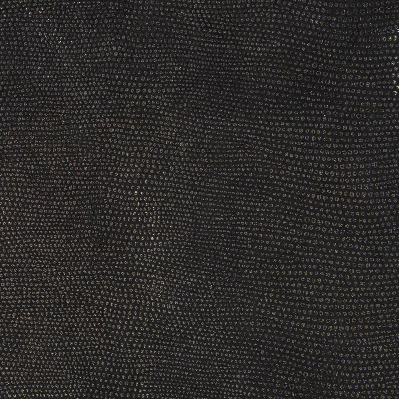 Close-up Pixel Gold Leather: textured black leather with small, shiny golden dots. Flat surface with subtle reflections.