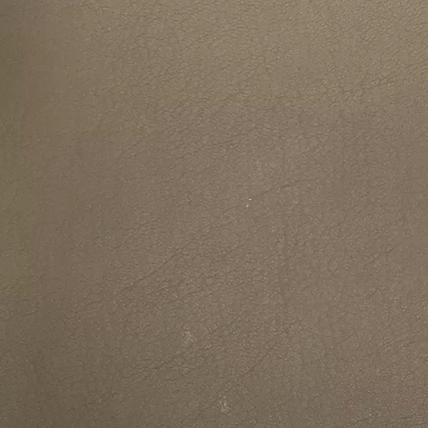 A close-up of Komodo 12412 Synthetic Leather shows a fine, slightly raised texture with subtle variations in a muted, medium brown.