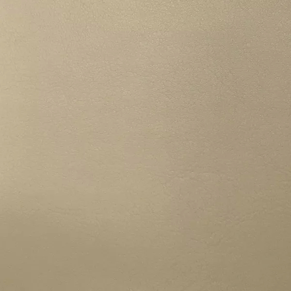 A close-up of Komodo 12414 Synthetic Leather shows a fine, slightly raised texture with subtle variations in a light, warm beige.