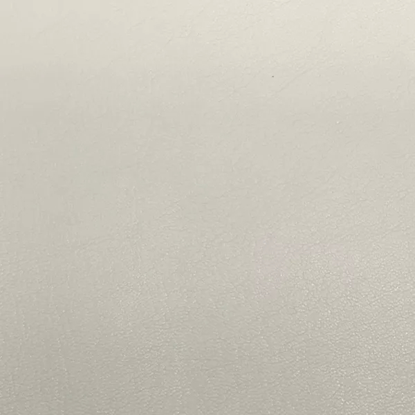 A close-up of Komodo 12420 Synthetic Leather shows a fine, slightly raised texture with subtle variations in a soft, light gray.