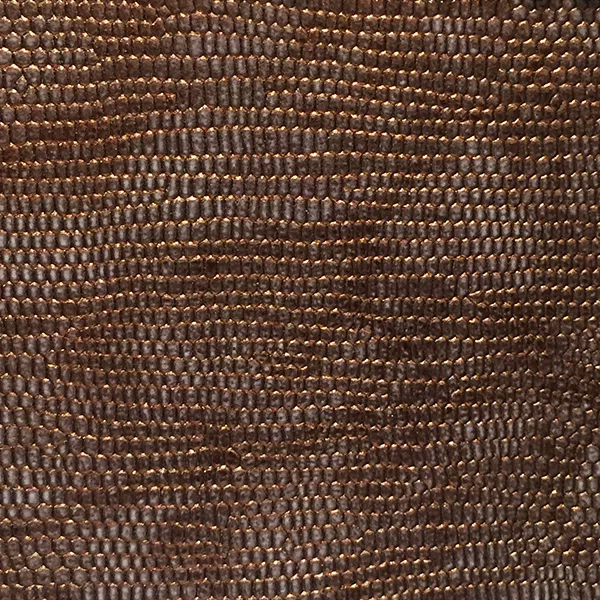 A detailed view of Ofidia Bronze Synthetic Leather reveals a rich, bronze, snake-like scale pattern with a subtle metallic shimmer.