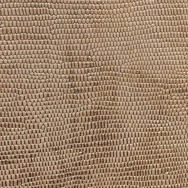 A detailed close-up of Ofidia Topaz Synthetic Leather shows a repeating, textured pattern resembling reptile scales in a warm, light brown tone.