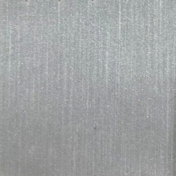 A close-up of Pearl Synthetic Leather in a light silver tone reveals a fine, vertical ribbed texture with a subtle, bright sheen.