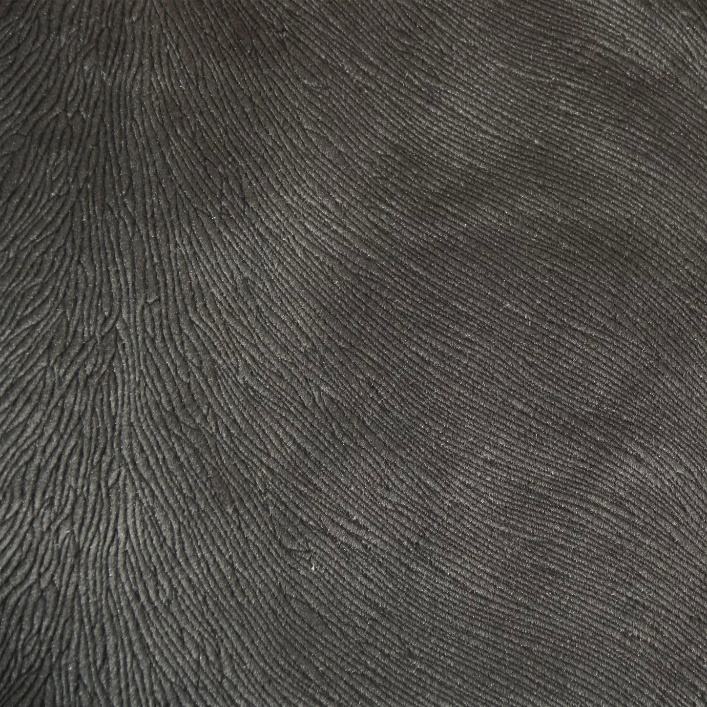 Detailed shot of textured Hide Velvet 020 fabric in a deep charcoal or dark gray shade.