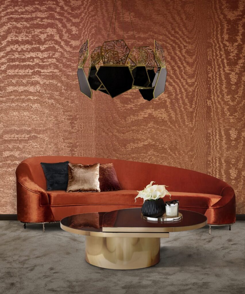 Dramatic living room color palette with earth tones featuring the Vamp Sofa, bronze chandelier and sculptural coffee table.