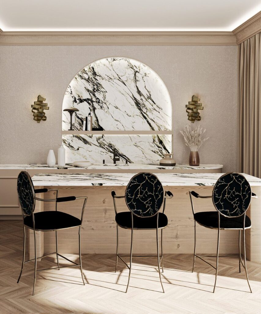 Whimsical brass wall sconce with ribbon-inspired design.