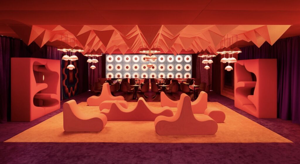 Bold red interior with sculptural furniture and immersive atmosphere